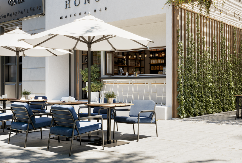 four indoor/outdoor armchairs around a table under and umbrella