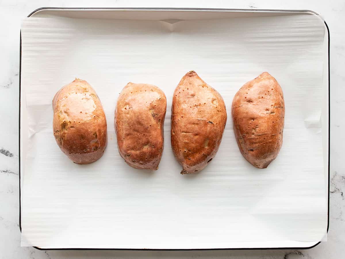 Prepped sweet potatoes on a baking sheet