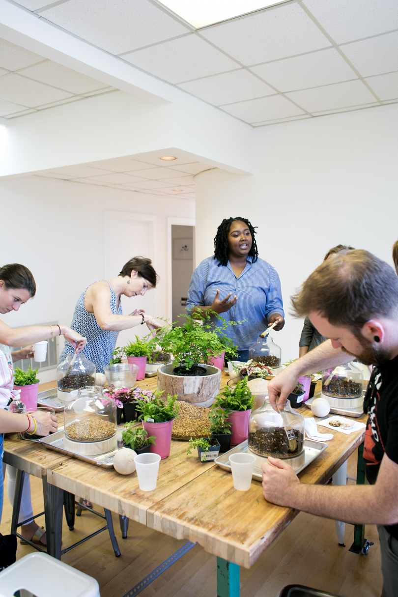 dark-skinned woman leading plant workshop
