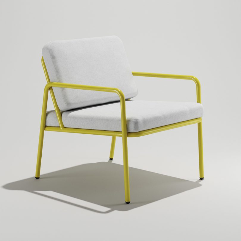 front of yellow indoor/outdoor armchair with white cushions on white background