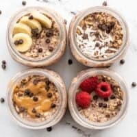 Overhead view of four jars of chocolate overnight oats, each with a different topping