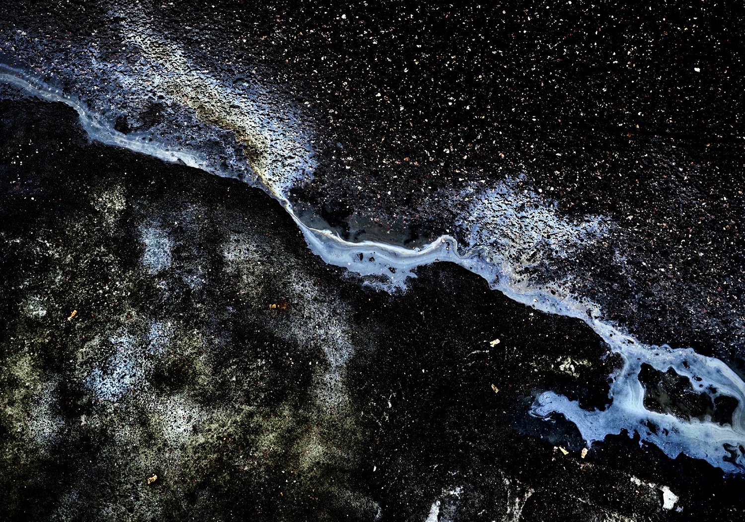 A photograph of Juha Tanhua's oil paintings which look like cosmic scenes from a telescope