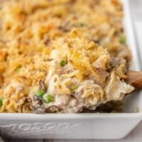 Side view of tuna noodle casserole being scooped out of the casserole dish