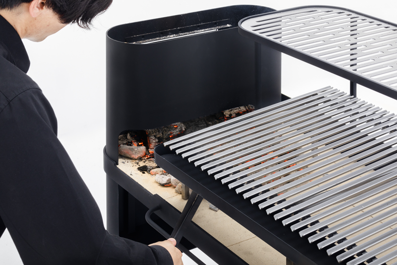 person preparing to cook on a black grill