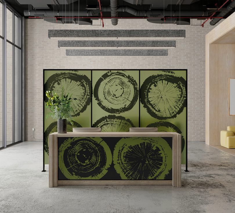 light wood console table sitting in front of panel with green tree stump patterns