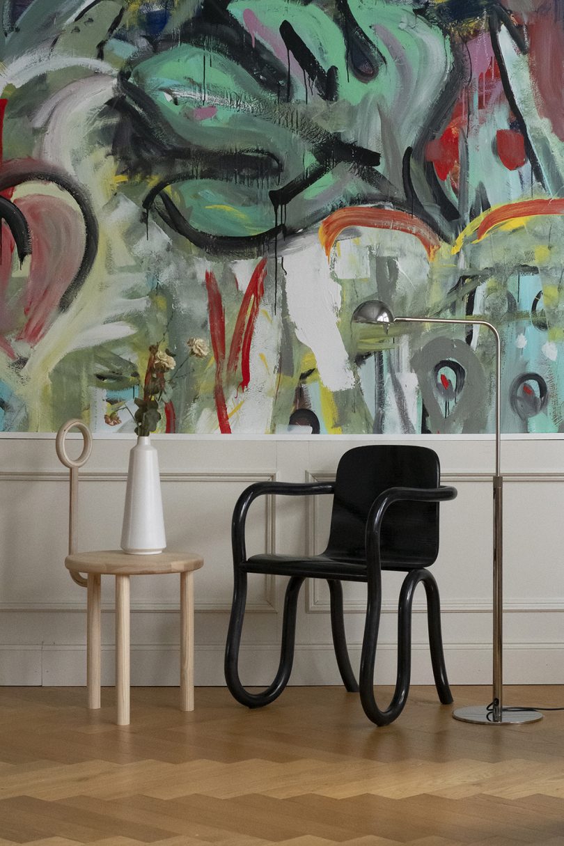 styled interior living space with black armchair and side table