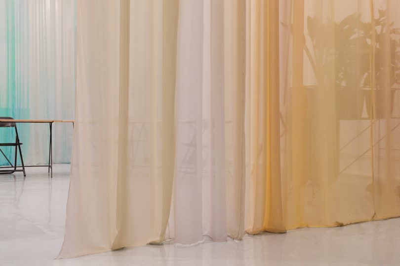 Curtains separate the space into three segments for flexibility