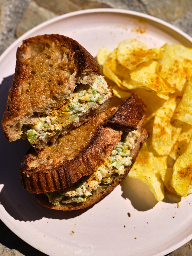 Cross-section View of Chickpea Salad Sandwich on a Plate cut in Half
