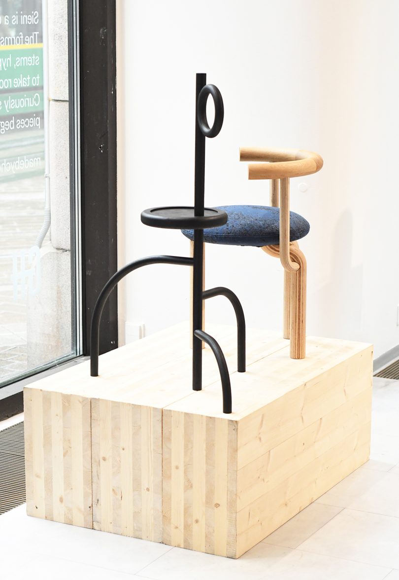 chair and side table in the window of a gallery space