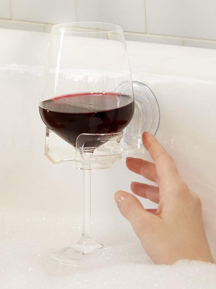 SipCaddy Shower Beer and Bath Wine Holder in a bathtub with a wine glass
