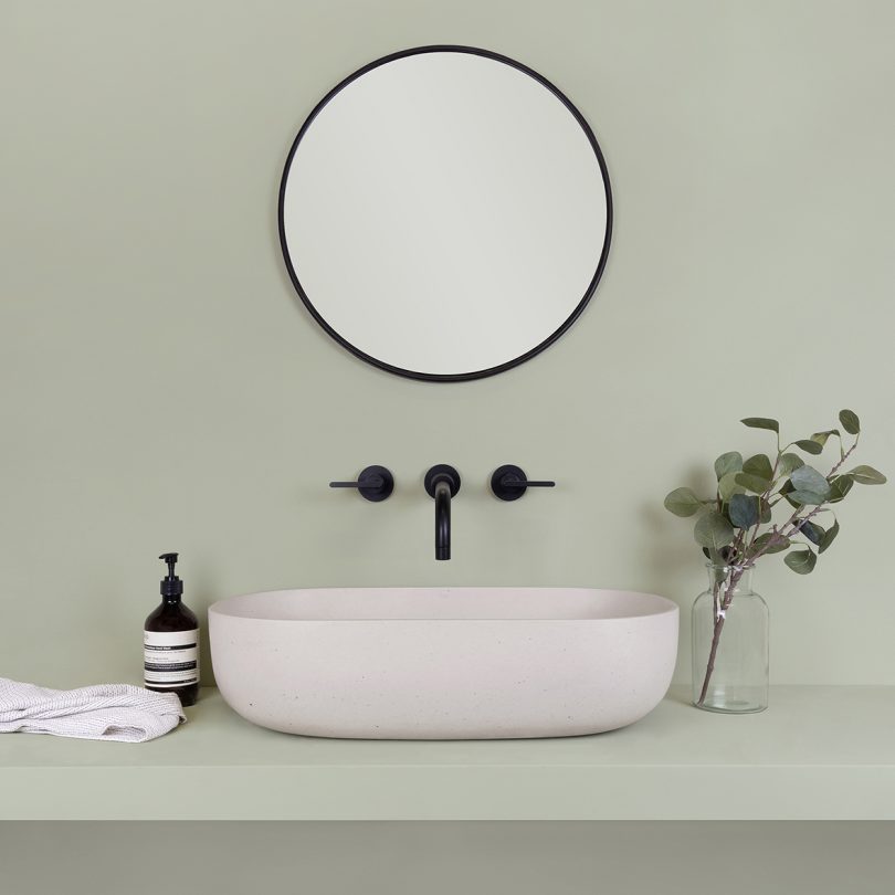 white bowl sink with black wall fixtures
