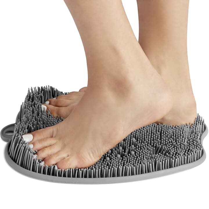 Feet using a Love, Lori Foot Scrubber on a white background