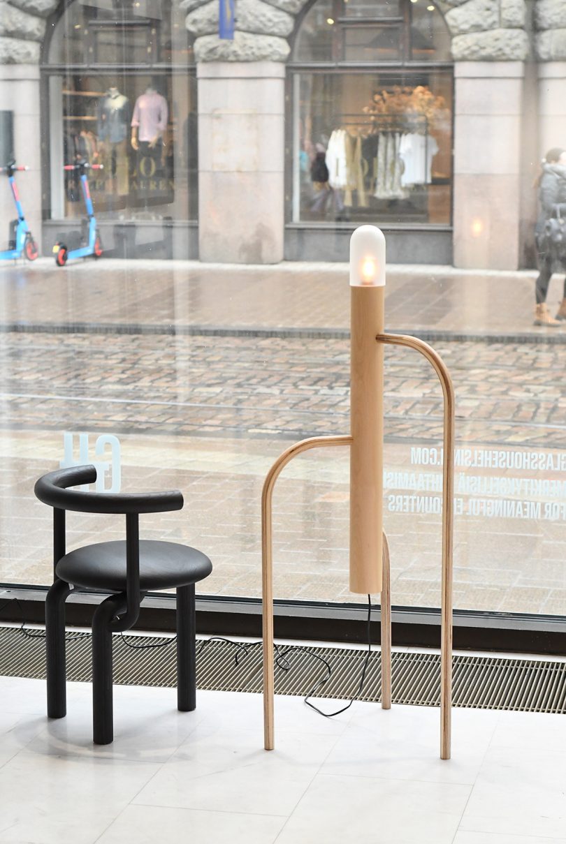 chair and lamp in the window of a gallery space