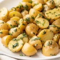 side view of a platter full of herby potato salad.
