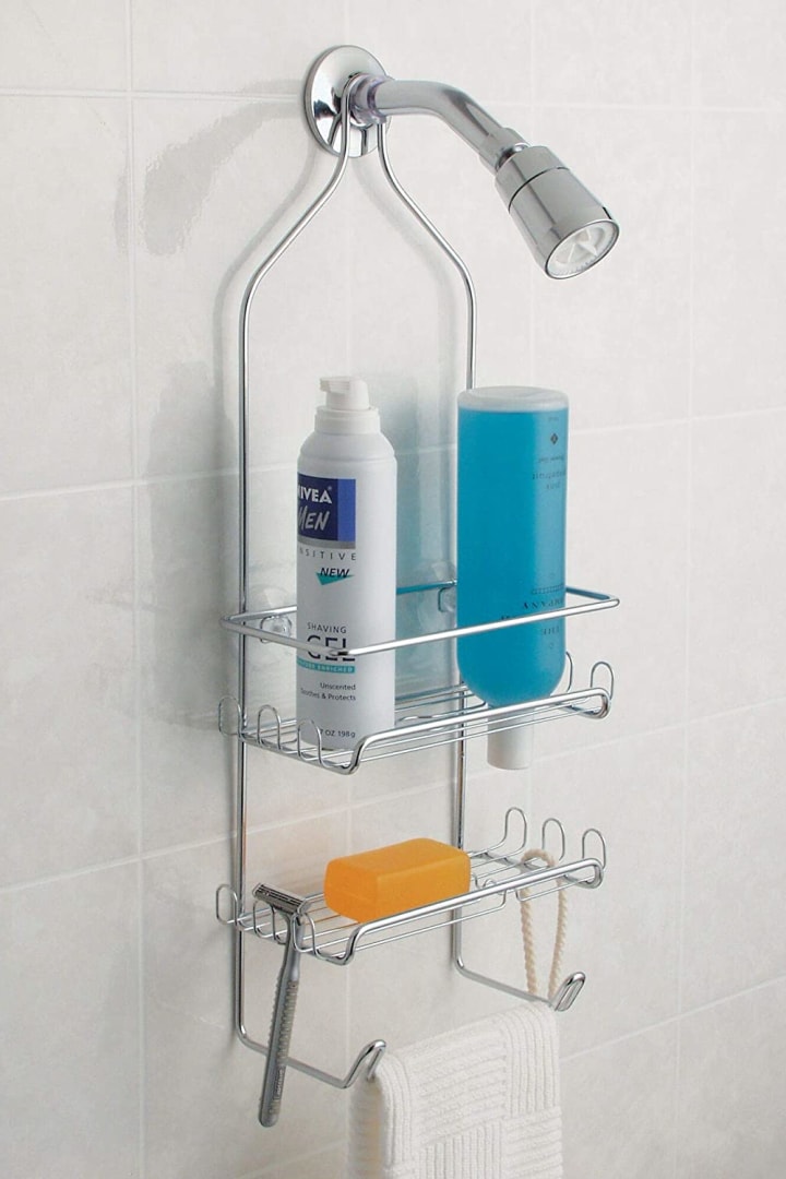 iDesign Milo Steel Hanging Shower Organizer hanging on a shower filled with products.