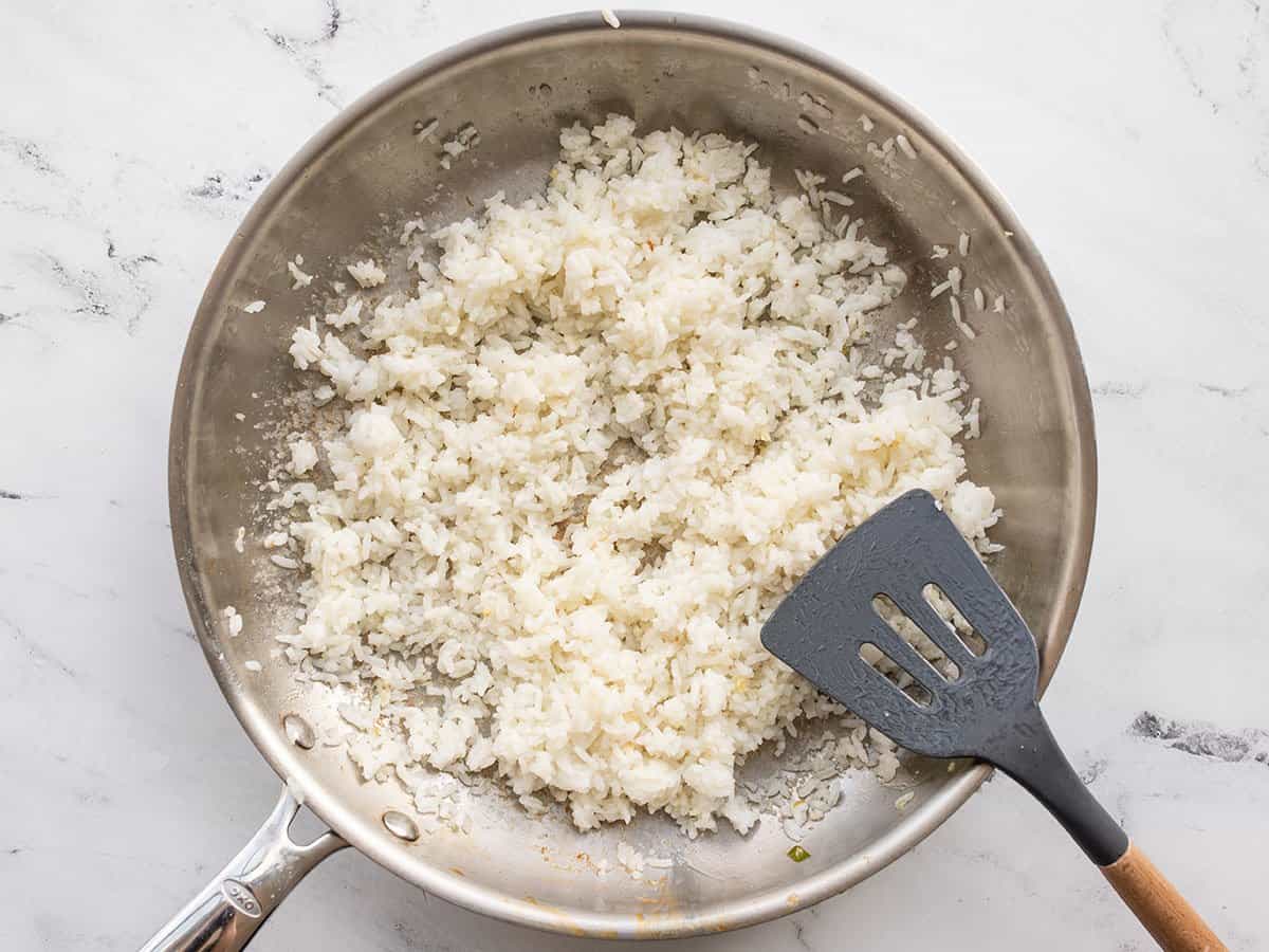 Stir fried rice in the skillet.