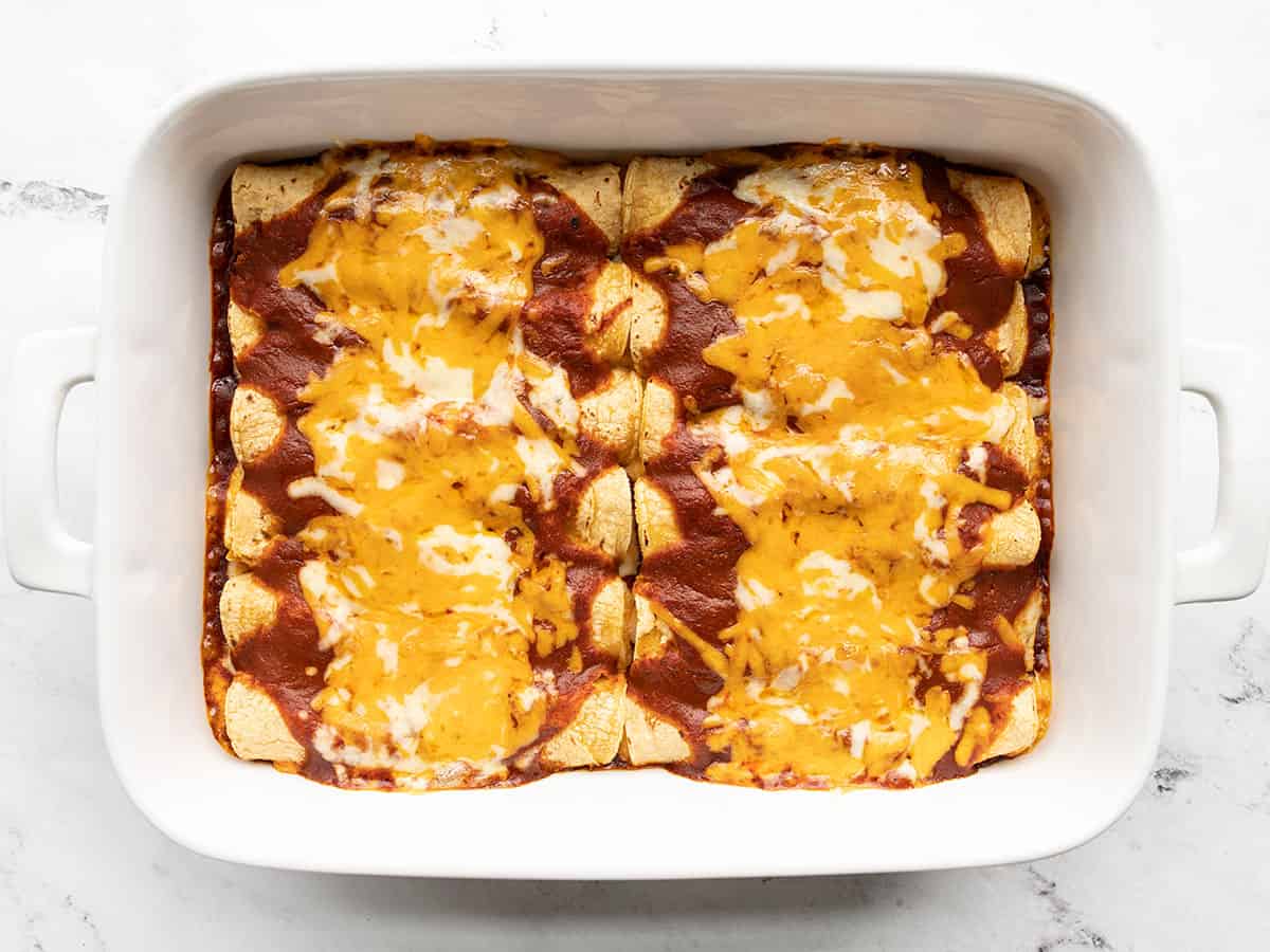 Baked enchiladas in the casserole dish.