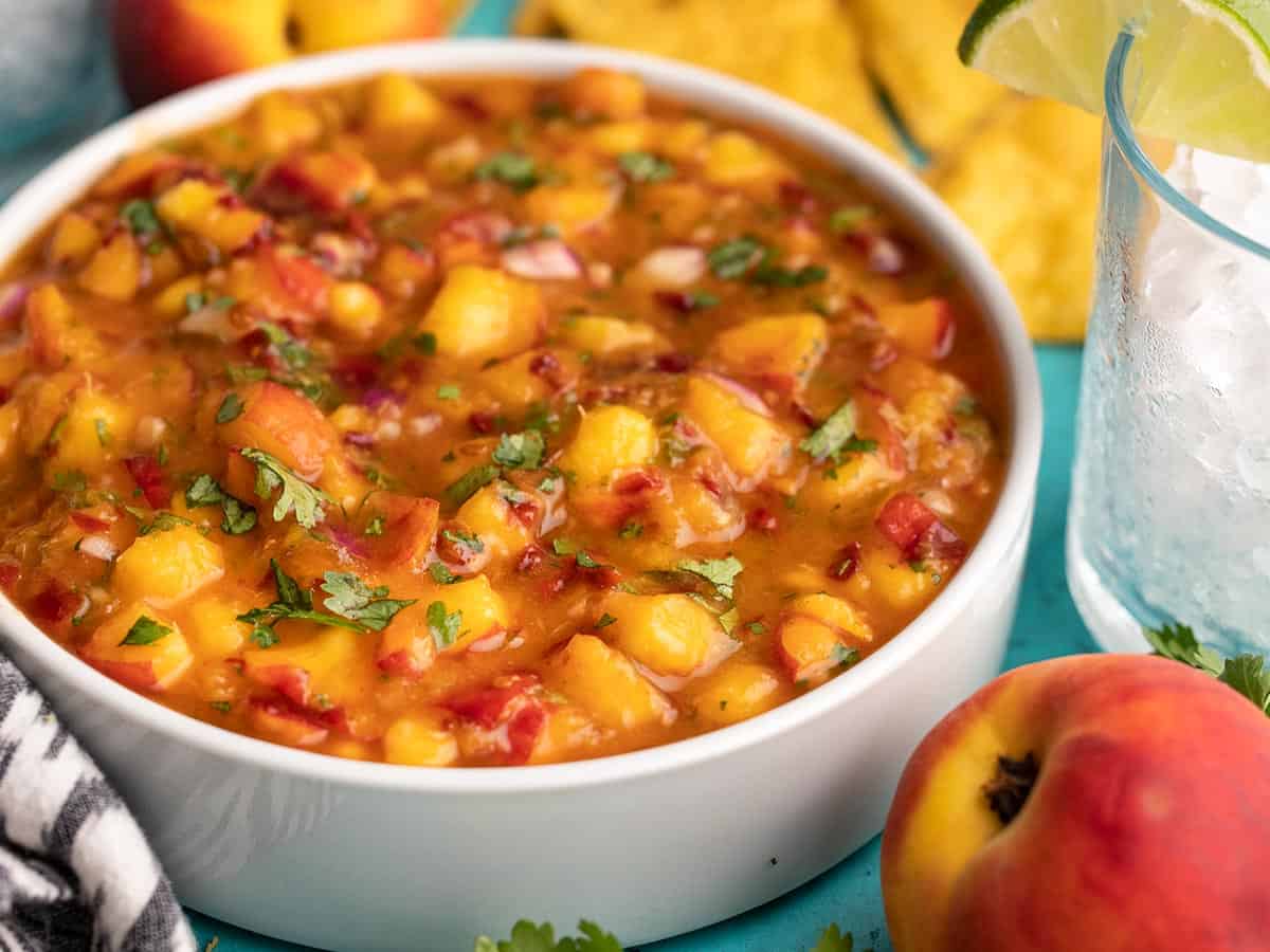 Side view of a bowl of chipotle peach salsa.