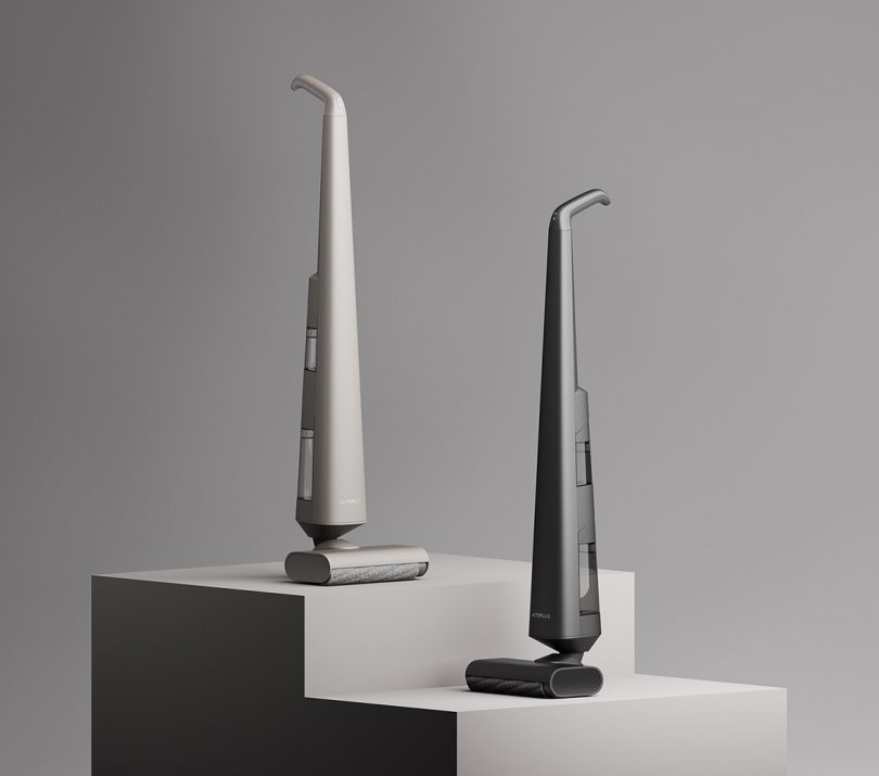 Actoplus Cordless Wet-Dry Vacuum Cleaner shown positioned on tiered pedestals, one in stone color, another in black.